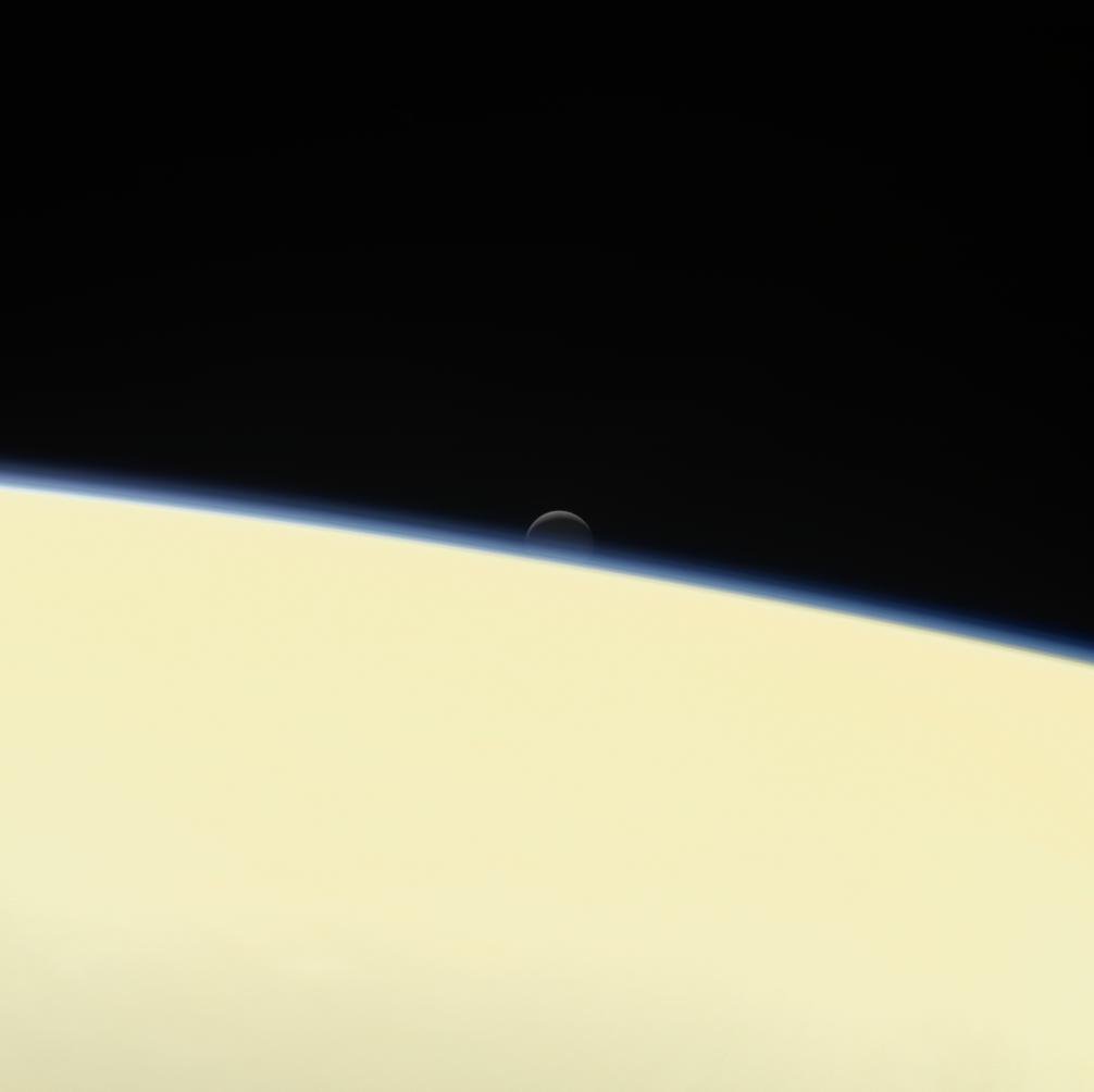 Enceladus setting behind Saturn, photographed by Cassini. The moon chart gives a projection rather than exact event contacts.